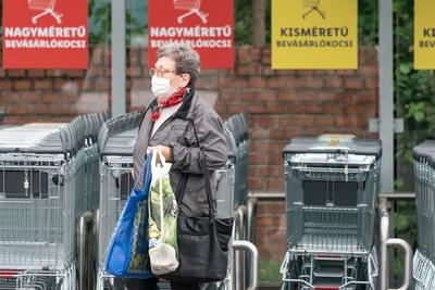 PECS - MAY 27 : Old woman go to shopping on the street  on 27 May 2020 in Pecs, Hungary. During coronavirus pandemic, everybody have to waering face mask-stock-photo