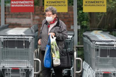 PECS - MAY 27 : Old woman go to shopping on the street  on 27 May 2020 in Pecs, Hungary. During coronavirus pandemic, everybody have to waering face mask-stock-photo