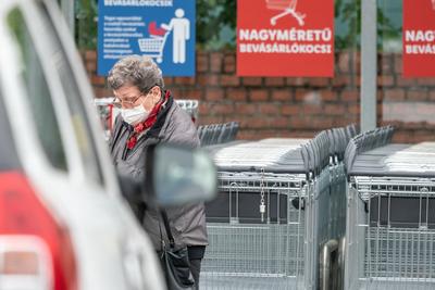 PECS - MAY 27 : Old woman go to shopping on the street  on 27 May 2020 in Pecs, Hungary. During coronavirus pandemic, everybody have to waering face mask-stock-photo