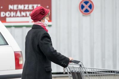 PECS - MAY 27 : Old woman go to shopping on the street  on 27 May 2020 in Pecs, Hungary. During coronavirus pandemic, everybody have to waering face mask-stock-photo