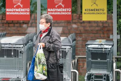 PECS - MAY 27 : Old woman go to shopping on the street  on 27 May 2020 in Pecs, Hungary. During coronavirus pandemic, everybody have to waering face mask-stock-photo