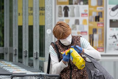 PECS - MAY 27 : Old woman go to shopping on the street  on 27 May 2020 in Pecs, Hungary. During coronavirus pandemic, everybody have to waering face mask-stock-photo