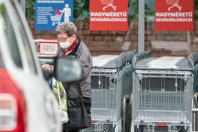 PECS - MAY 27 : Old woman go to shopping on the street  on 27 May 2020 in Pecs, Hungary. During coronavirus pandemic, everybody have to waering face mask-stock-photo