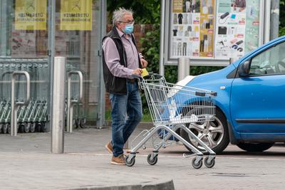 PECS - MAY 27 : Old man go to shopping on the street  on 27 May 2020 in Pecs, Hungary. During coronavirus pandemic, everybody have to waering face mask-stock-photo