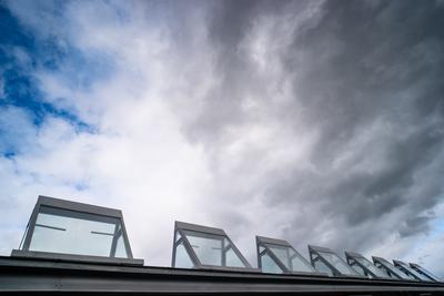 roof windows on a modern building  with cloudy sky-stock-photo