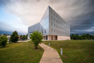 Modern office building wall made of steel and glass with cloudy sky-stock-foto
