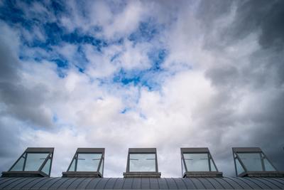 roof windows on a modern building  with cloudy sky-stock-photo