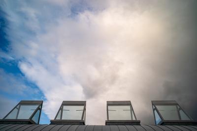 roof windows on a modern building  with cloudy sky-stock-photo