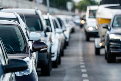 Many cars travelling on a road-stock-photo