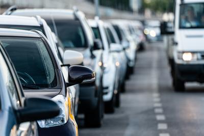 Many cars travelling on a road-stock-photo