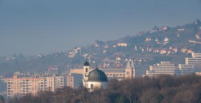 Small chapel in Pecs, Hungary with block houses-stock-photo