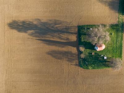 aerial photo of a small chapel with morning sunshine-stock-photo