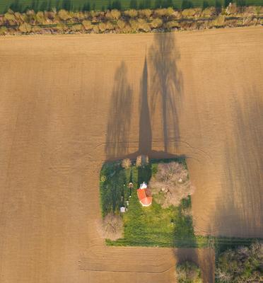 aerial photo of a small chapel with morning sunshine-stock-photo