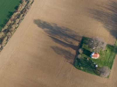 aerial photo of a small chapel with morning sunshine-stock-photo