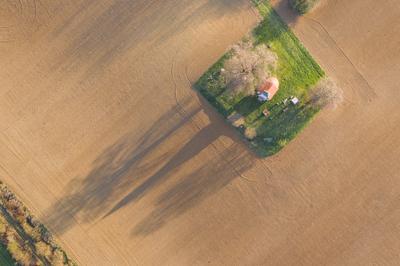 aerial photo of a small chapel with morning sunshine-stock-photo