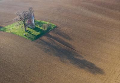 aerial photo of a small chapel with morning sunshine-stock-photo