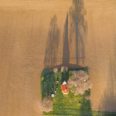 aerial photo of a small chapel with morning sunshine-stock-photo