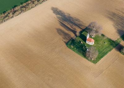 aerial photo of a small chapel with morning sunshine-stock-foto
