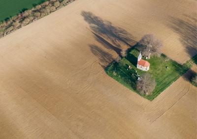 aerial photo of a small chapel with morning sunshine-stock-photo