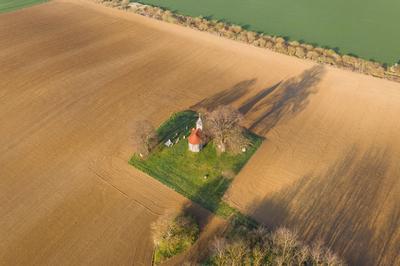 aerial photo of a small chapel with morning sunshine-stock-photo