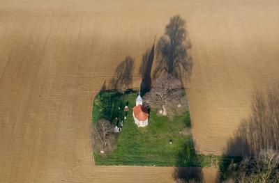 aerial photo of a small chapel with morning sunshine-stock-photo