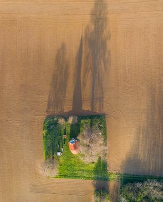 aerial photo of a small chapel with morning sunshine-stock-photo