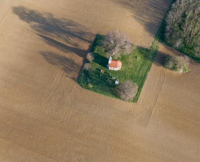 aerial photo of a small chapel with morning sunshine-stock-photo