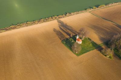 aerial photo of a small chapel with morning sunshine-stock-photo