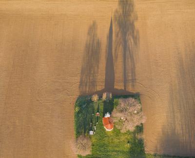 aerial photo of a small chapel with morning sunshine-stock-photo