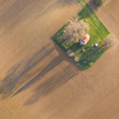 aerial photo of a small chapel with morning sunshine-stock-photo