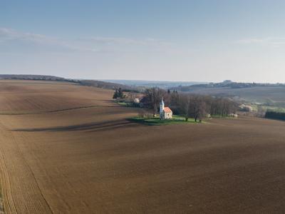 aerial photo of a small chapel with morning sunshine-stock-photo