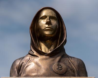 Budapest, Hungary -August 7, .2022:  Portrait of the statue of Satoshi Nakamoto mysterious founder of Bitcoin and Blockchain technology in; created by Reka Gergely and Tamas Gilly.  August 7, .2022 in Budapest, Hungary.-stock-photo