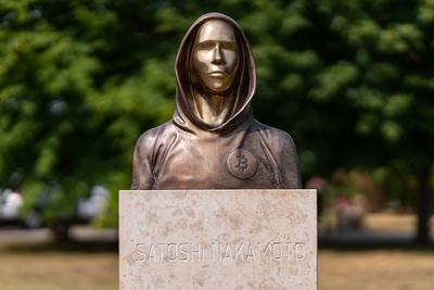 Budapest, Hungary -August 7, .2022:  Portrait of the statue of Satoshi Nakamoto mysterious founder of Bitcoin and Blockchain technology in; created by Reka Gergely and Tamas Gilly.  August 7, .2022 in Budapest, Hungary.-stock-photo