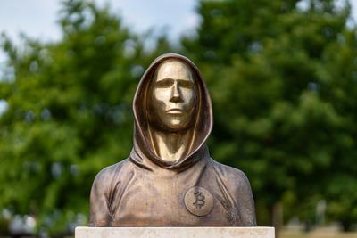 Budapest, Hungary -August 7, .2022:  Portrait of the statue of Satoshi Nakamoto mysterious founder of Bitcoin and Blockchain technology in; created by Reka Gergely and Tamas Gilly.  August 7, .2022 in Budapest, Hungary.-stock-photo