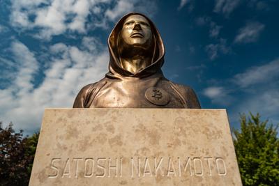 Budapest, Hungary -August 7, .2022:  Portrait of the statue of Satoshi Nakamoto mysterious founder of Bitcoin and Blockchain technology in; created by Reka Gergely and Tamas Gilly.  August 7, .2022 in Budapest, Hungary.-stock-photo