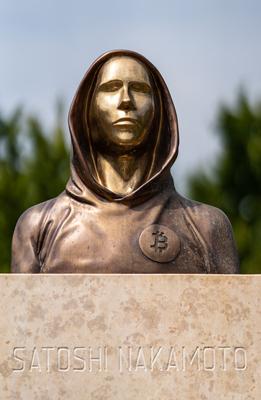 Budapest, Hungary -August 7, .2022:  Portrait of the statue of Satoshi Nakamoto mysterious founder of Bitcoin and Blockchain technology in; created by Reka Gergely and Tamas Gilly.  August 7, .2022 in Budapest, Hungary.-stock-photo
