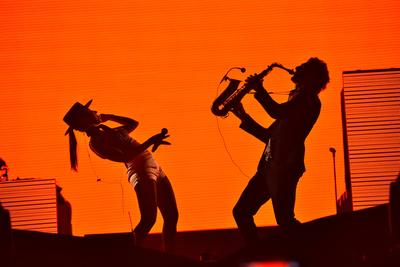 CLUJ-NAPOCA, ROMANIA - AUGUST 7, 2016: Silhouette of singer Cleo Panther (left) and saxophone player from Parov Stelar Band performing live on the stage at Untold Festival-stock-photo