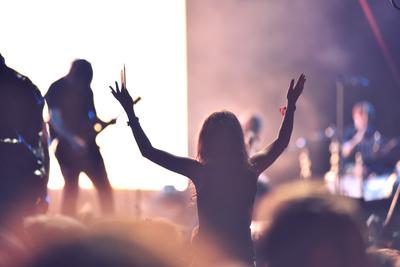 Crowd at a music concert, audience raising hands up-stock-photo