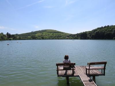 Bánk, 13 May 2018Woman seating on a Pier at the Lake of Bánk (Northern Hungary).Stégen ülõ hölgy a Bánki-tavon.-stock-photo