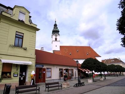 Pedesrian street and Virgin Mary Church - Mosonmagyaróvár-stock-photo