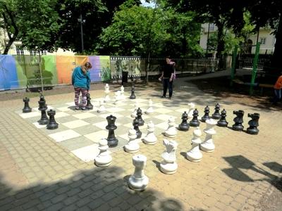 Children playing Chess - Giant Chessboard - Game-stock-photo