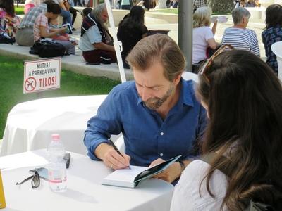 Hungarian writer dedicating his book at the Budapest International Book Festival-stock-photo