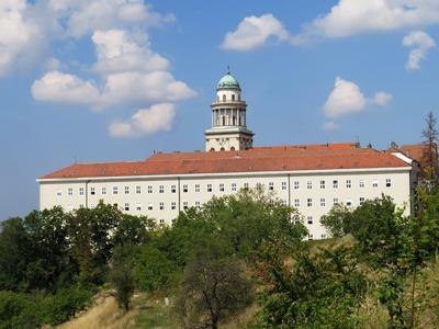 The high school dormitory of the Pannonhalma Archabbey and the tower of its basilica - Hungary-stock-photo