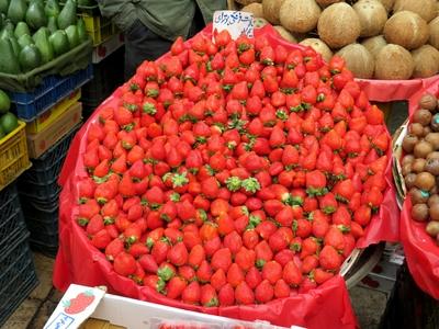 Strawberries, avocado, coconut and figs on a counter in Tehran's Grand Bazaar-stock-photo