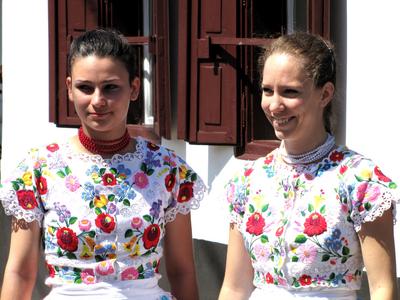Girls dressed in embroidered folk costumes in Mezőkövesd - Hungary-stock-photo