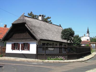 Mezőkövesd - Traditional House and Church-stock-photo