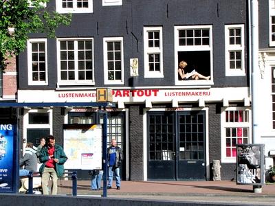 Sunbathing Man in a Window of Amsterdam-stock-foto