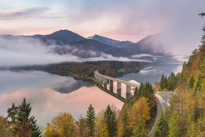 Sylvenstein Lake and bridge surrounded by the morning mist at dawn. Bad TÃ¶lz-Wolfratshausen district, Bavaria, Germany.-stock-photo