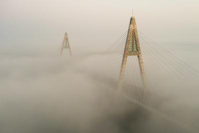 Foggy sunrise at Megyeri bridge. The Megyeri bridge is located on the northern border of budapest. A part of M0 ring road.Drive carefuly when the weather is misty.-stock-photo