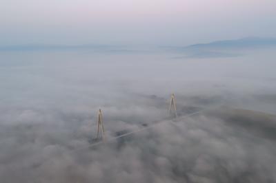 Foggy sunrise at Megyeri bridge. The Megyeri bridge is located on the northern border of budapest. A part of M0 ring road.Drive carefuly when the weather is misty.-stock-photo